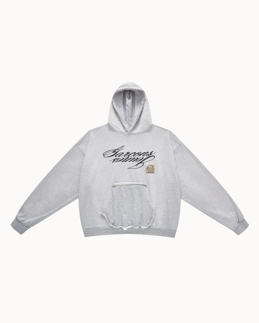 Heather grey reversible hoodie, front view with the mirrored Garçons Jeunes script and the photo patch