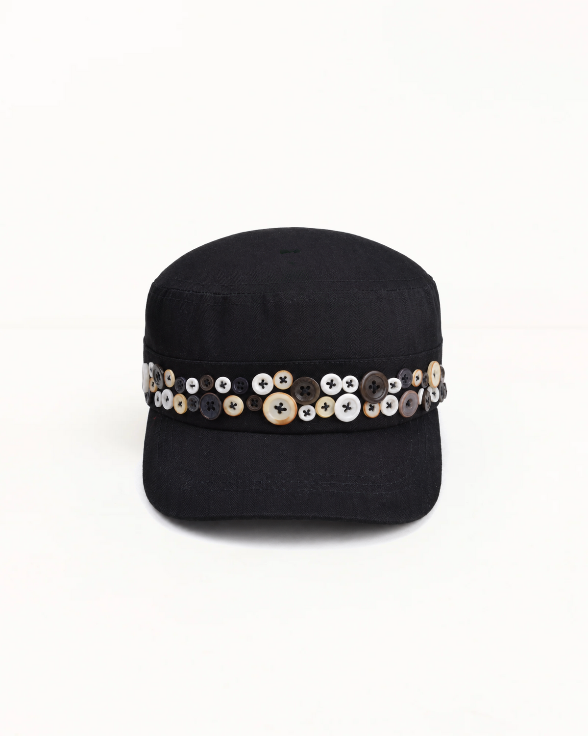 Black herringbone twill cadet cap, band set with mismatched pearl and horn buttons