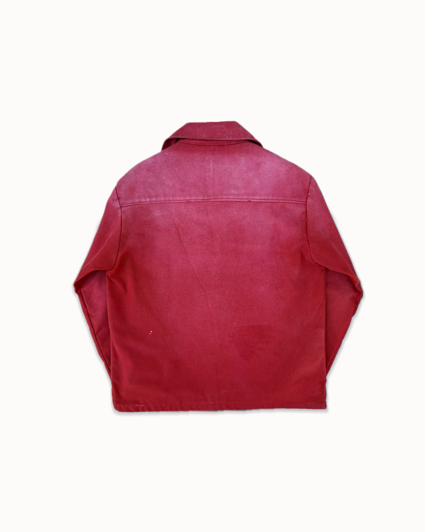 Burgundy cotton canvas vareuse, back view with the yoke seam across the upper back